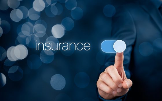 Insurance concept. Businessman (or insurance agent) switch over insurance bokeh in background.